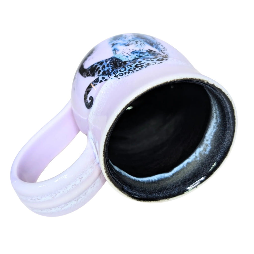 White mug with black interior and handle, featuring a blue and black design on a white background