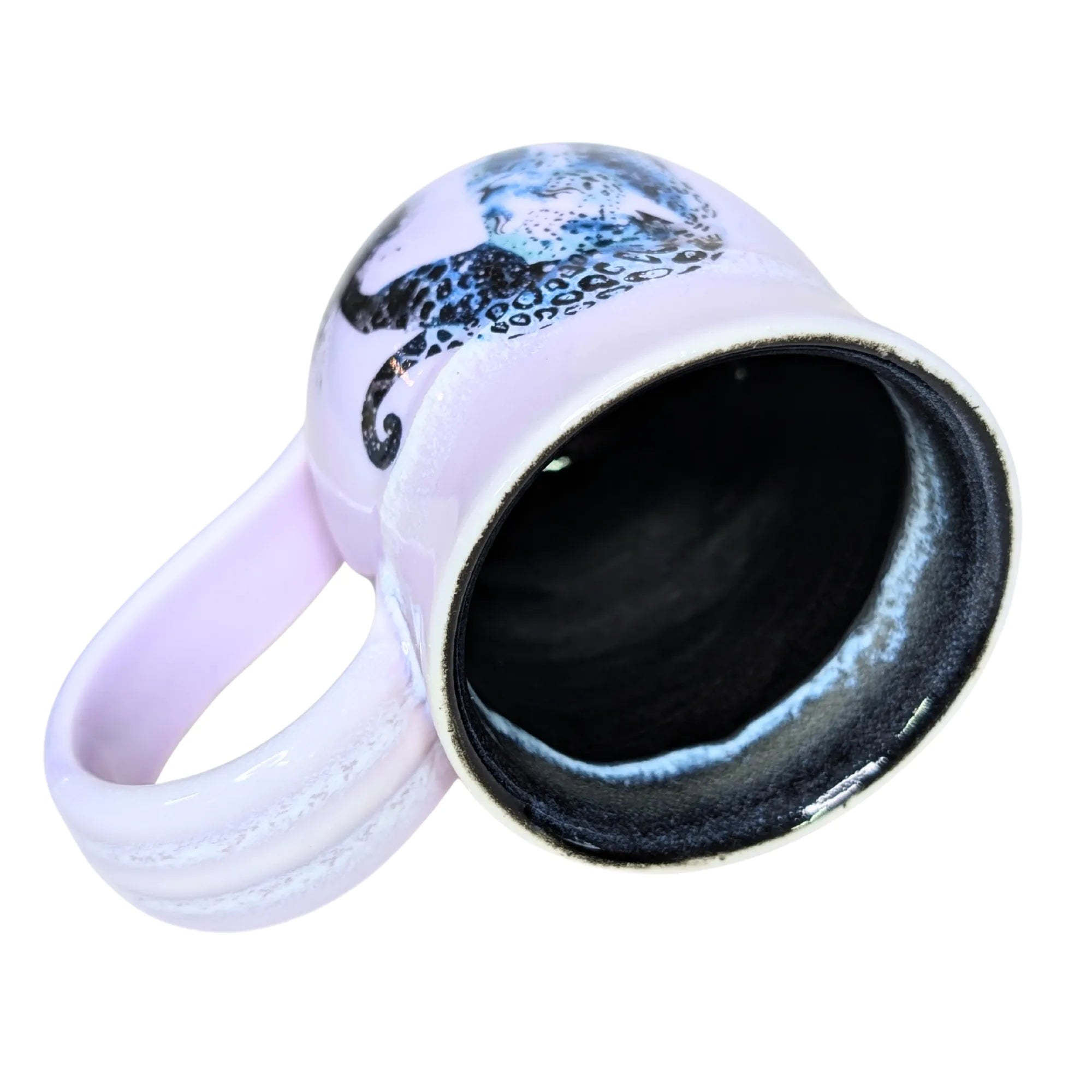 White mug with black interior and handle, featuring a blue and black design on a white background