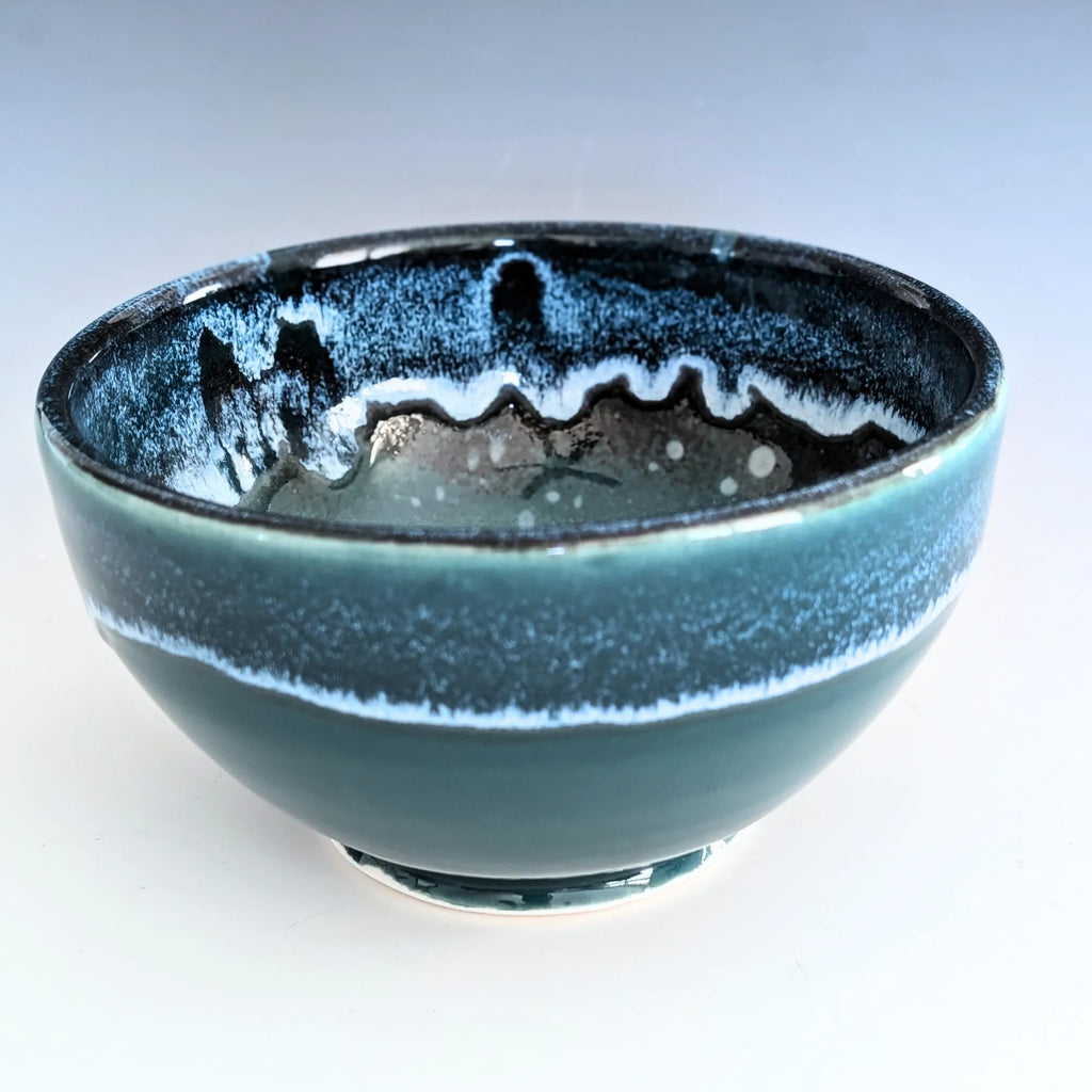 Blue ceramic bowl with textured surface on a white background