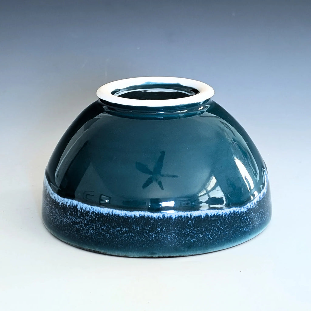 Blue ceramic bowl with a white rim on a gradient background