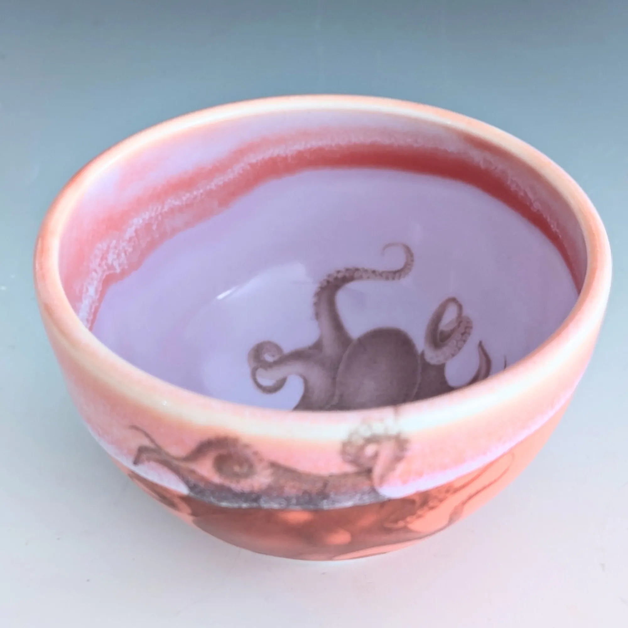 Ceramic bowl with octopus design on a light blue background