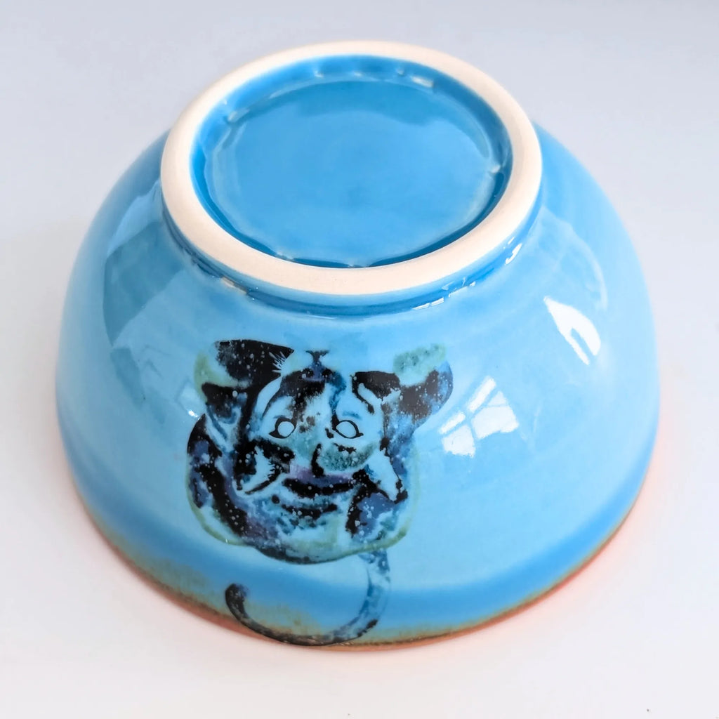 Blue ceramic bowl with a tiger design on a white background
