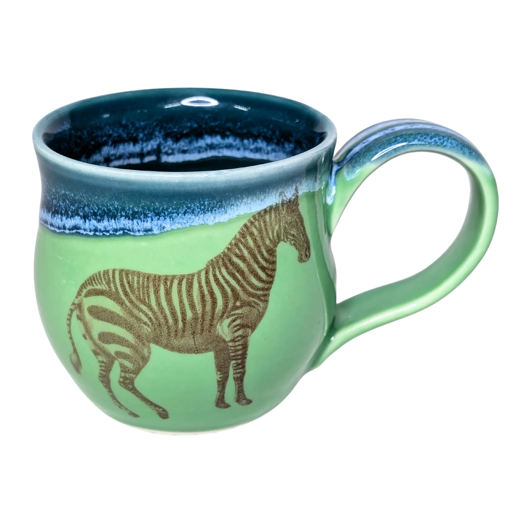 Green mug with zebra design and blue interior on a white background