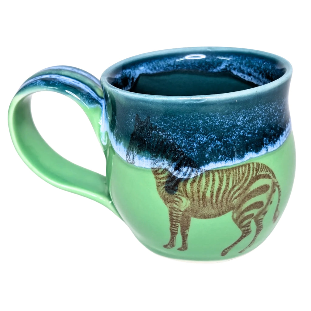 Green mug with zebra design and blue interior on a white background