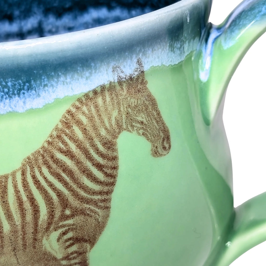 Green mug with a zebra design on a white background