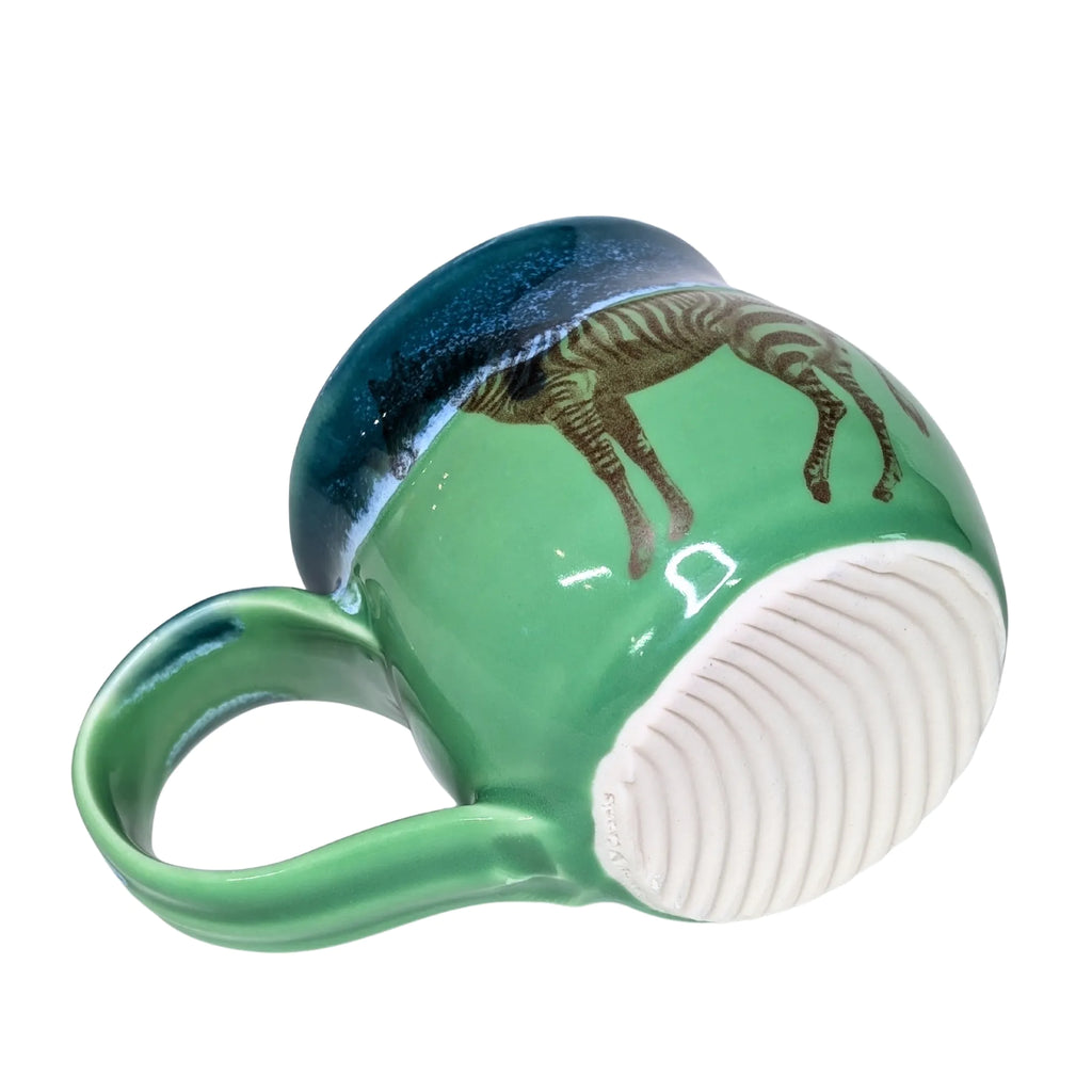 Green mug with zebra design on a white background